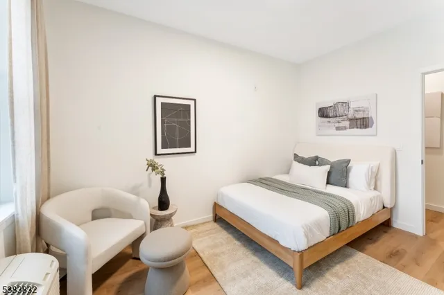 a bedroom with a bed and glass wall