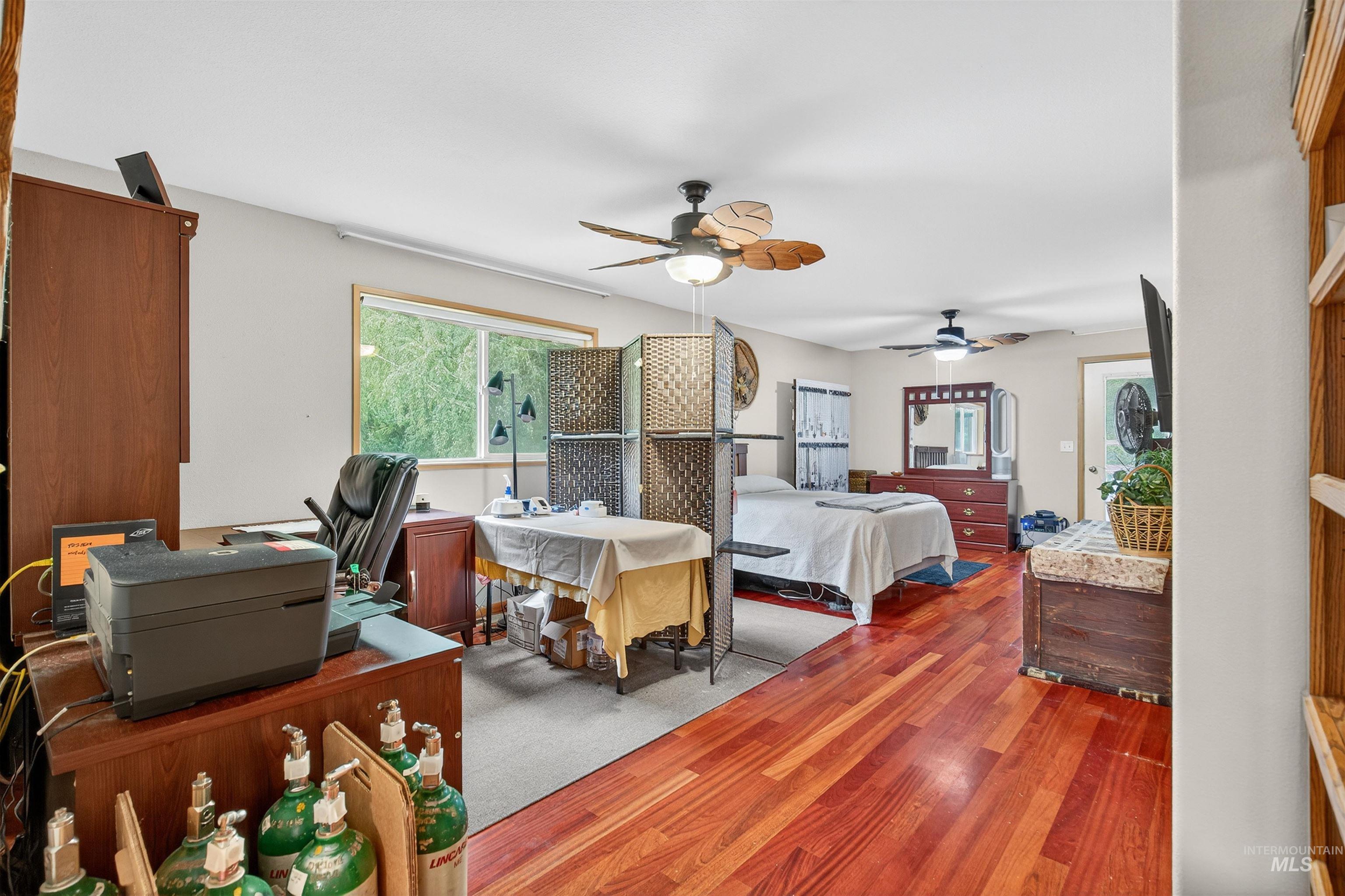 8385 Asotin Creek Road Asotin, WA 99402 - Photo 24 of 46 Bedroom featuring wood finished floors, ceiling fan, and a desk