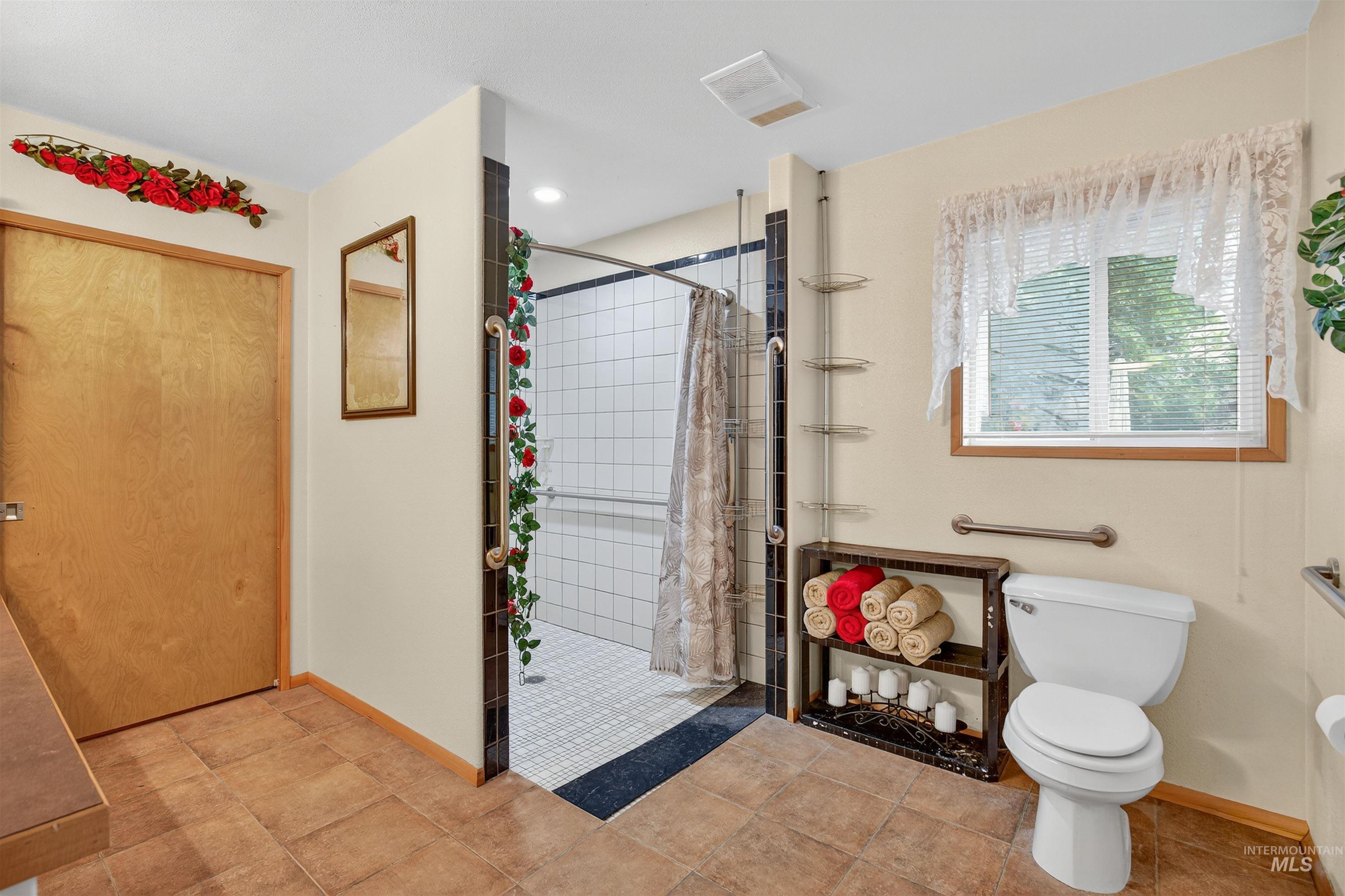 8385 Asotin Creek Road Asotin, WA 99402 - Photo 28 of 46 Bathroom with a stall shower and light tile patterned flooring