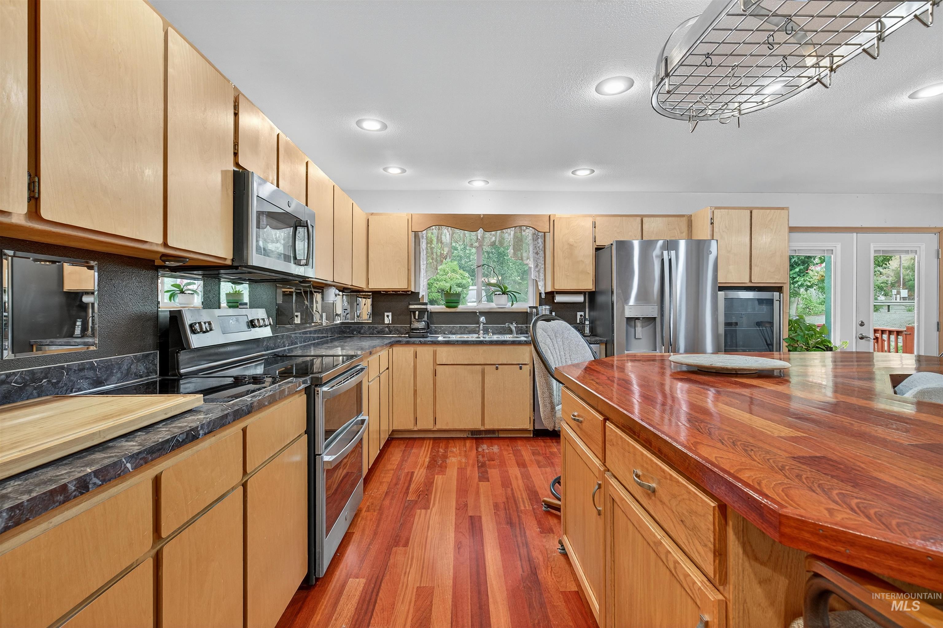 8385 Asotin Creek Road Asotin, WA 99402 - Photo 10 of 46 Kitchen featuring appliances with stainless steel finishes, light wood-type flooring, recessed lighting, wooden counters, and light brown cabinets