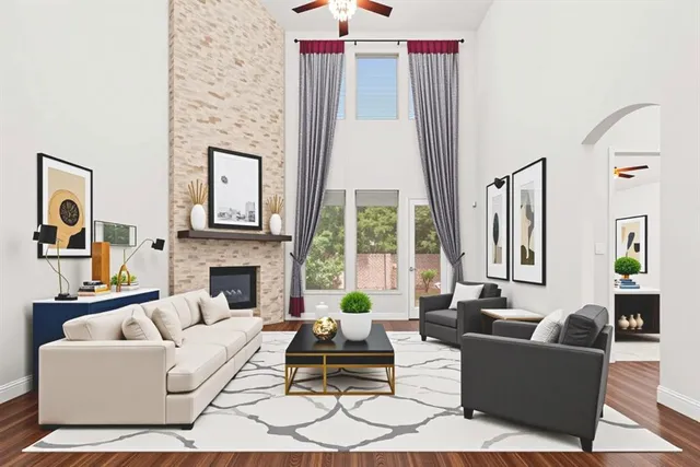 a living room with furniture large window and fireplace