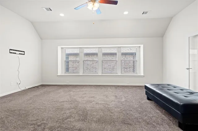 a living room with a bed furniture and a window