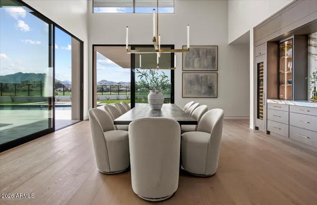 a view of a living room and floor to ceiling window and a swimming pool