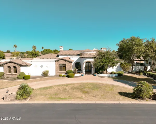 an aerial view of a house with a yard and garage