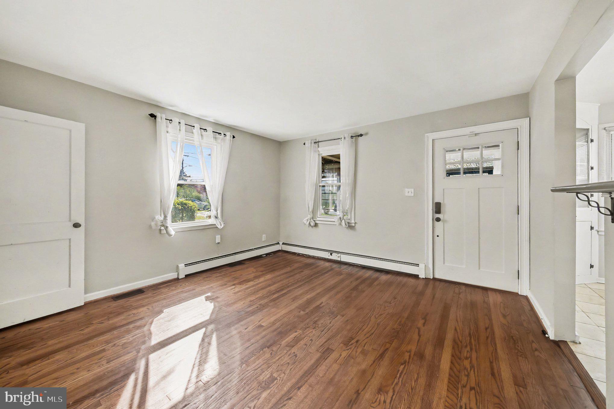 1750 Forrest Avenue Baltimore, MD 21234 - Photo 11 of 25 an empty room with wooden floor and windows