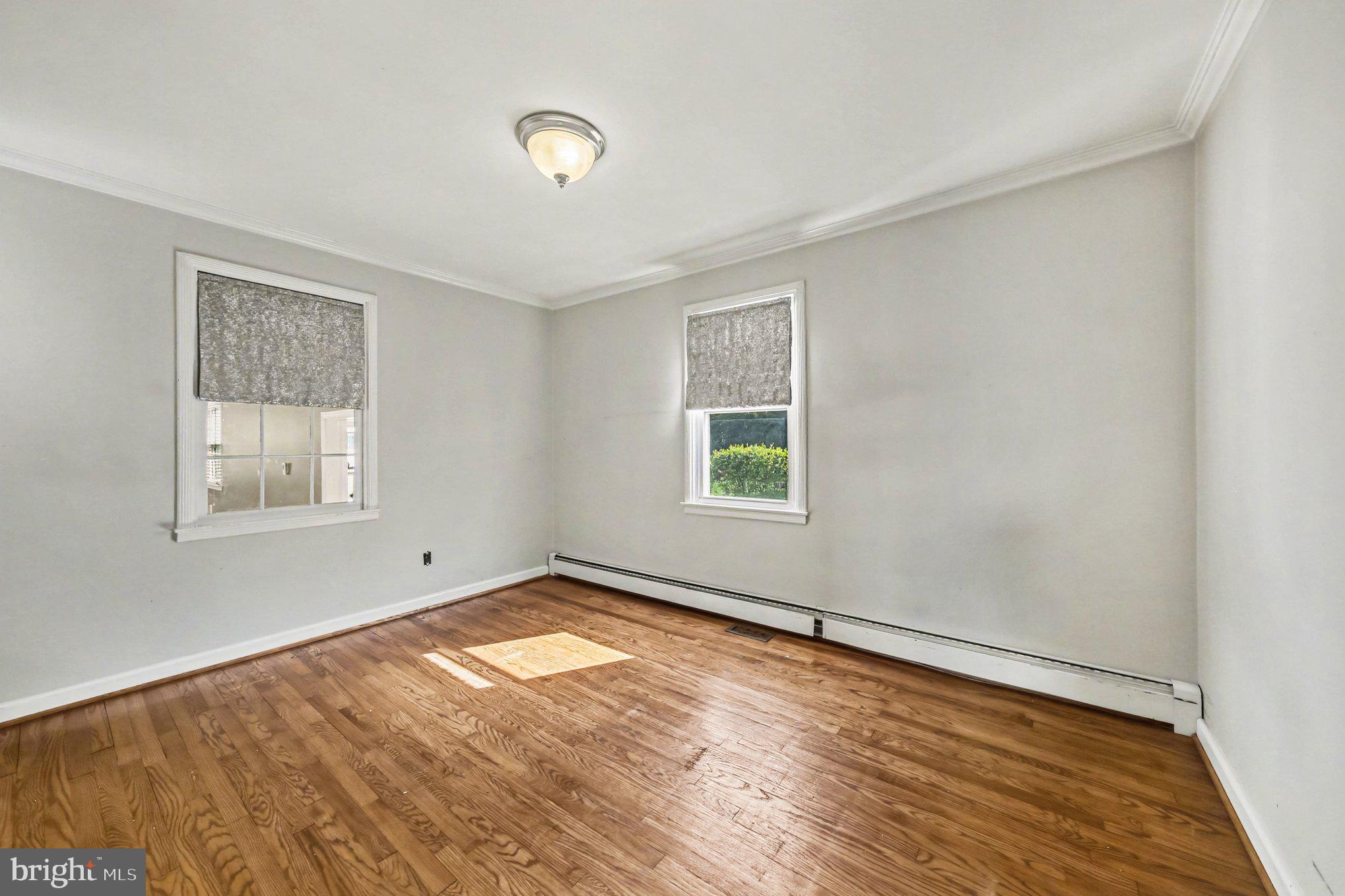 1750 Forrest Avenue Baltimore, MD 21234 - Photo 13 of 25 wooden floor in an empty room with a window