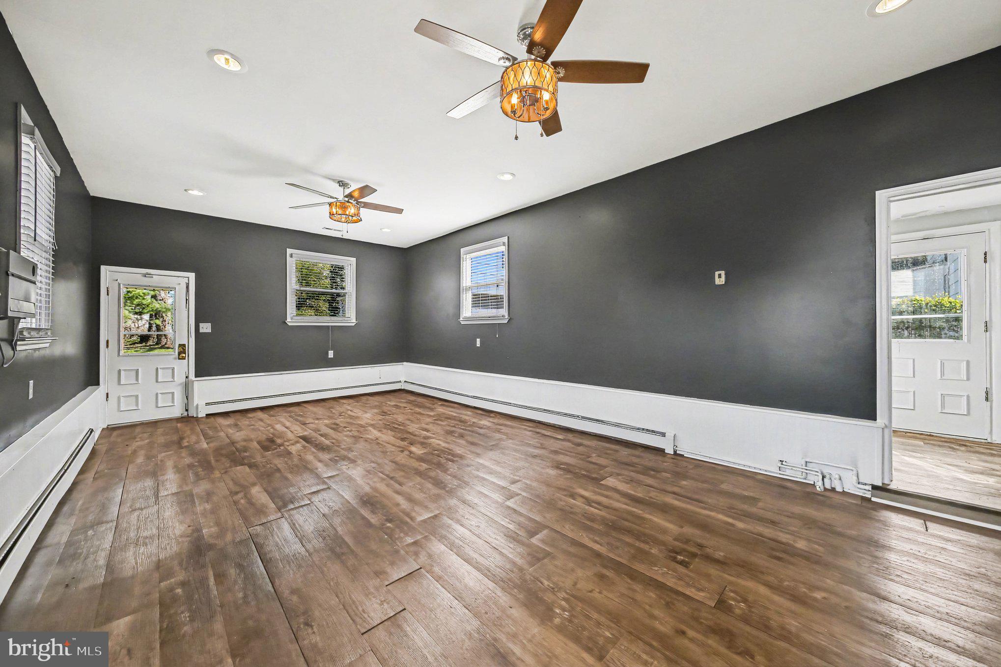 1750 Forrest Avenue Baltimore, MD 21234 - Photo 15 of 25 a view of an empty room with window and wooden floor