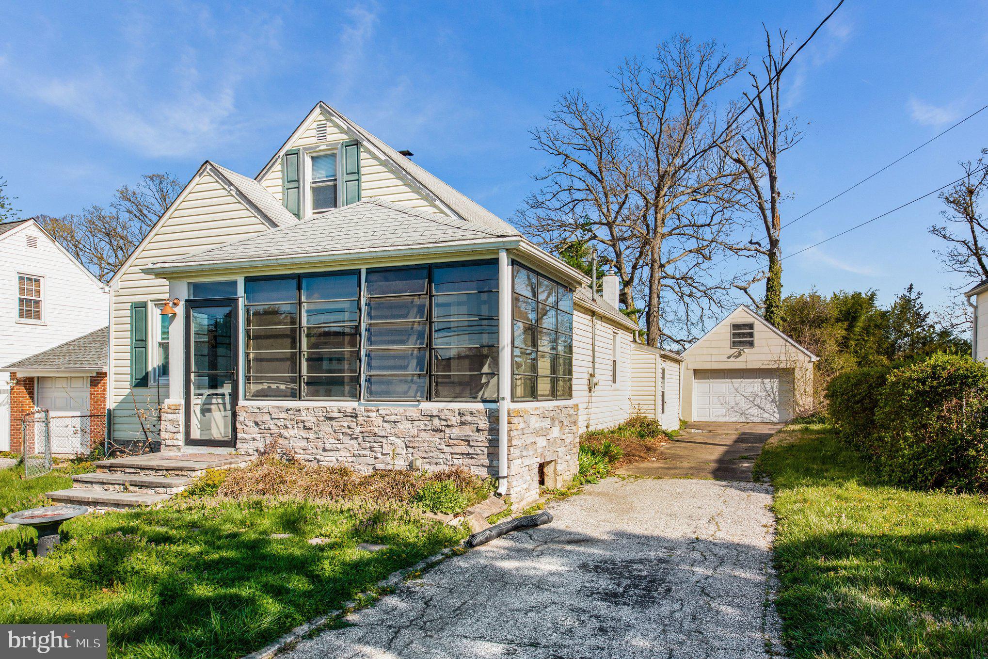 1750 Forrest Avenue Baltimore, MD 21234 - Photo 2 of 25 a front view of a house with a garden and yard