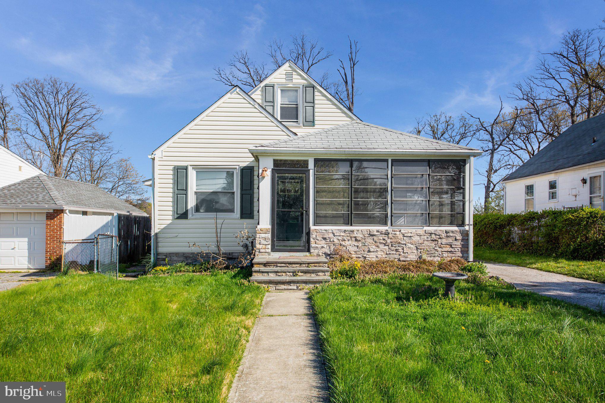1750 Forrest Avenue Baltimore, MD 21234 - Photo 3 of 25 a front view of a house with a yard and porch