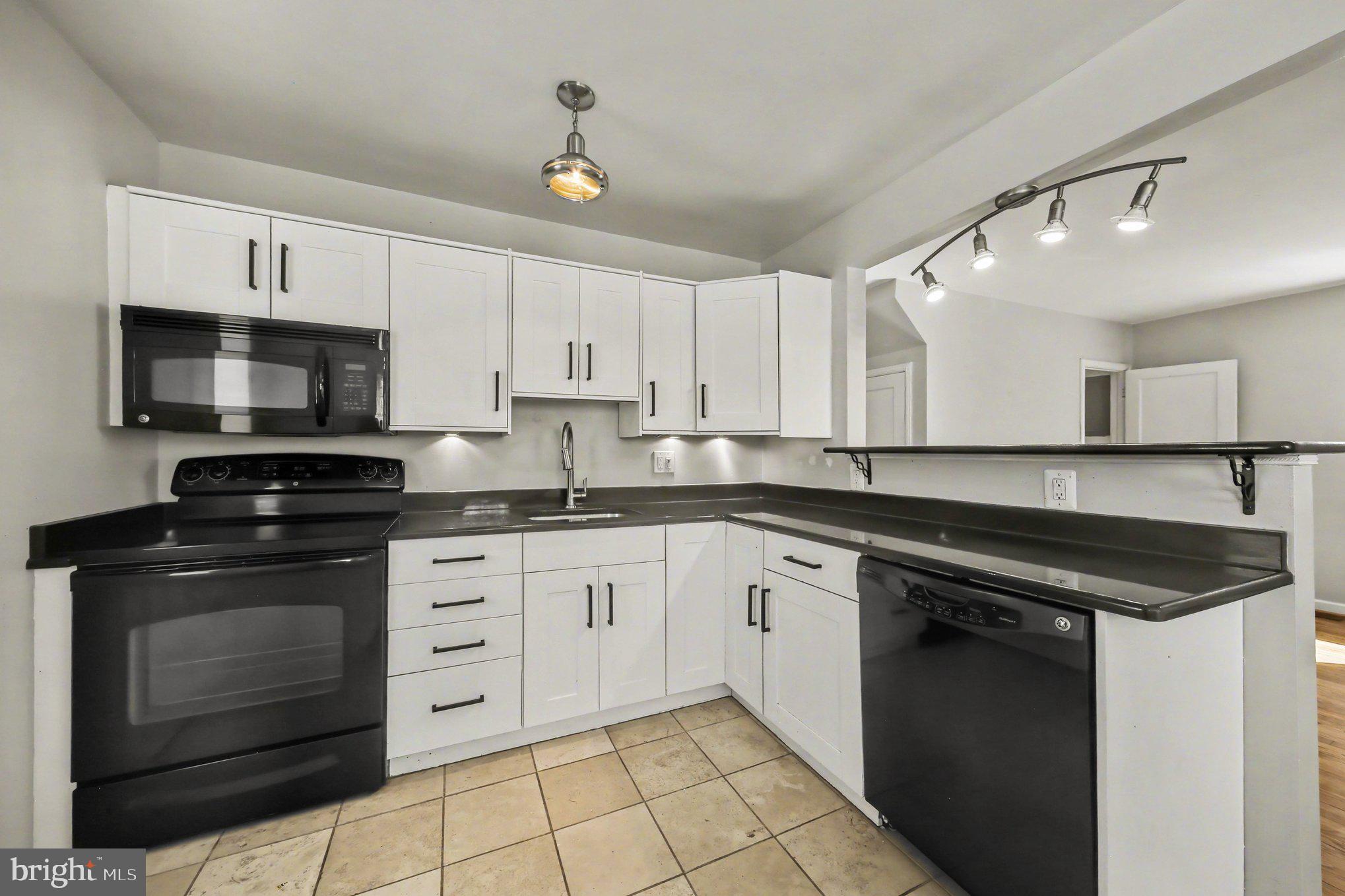 1750 Forrest Avenue Baltimore, MD 21234 - Photo 6 of 25 a kitchen with granite countertop a stove sink and cabinets