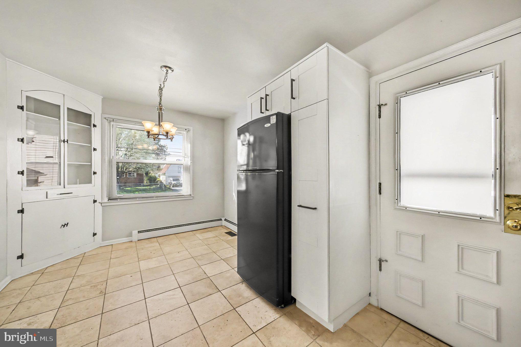 1750 Forrest Avenue Baltimore, MD 21234 - Photo 7 of 25 a view of a kitchen with white cabinets and refrigerator