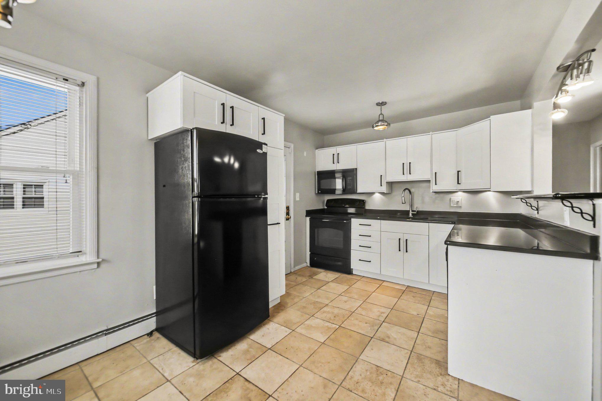 1750 Forrest Avenue Baltimore, MD 21234 - Photo 8 of 25 a kitchen with stainless steel appliances granite countertop a refrigerator and a stove top oven