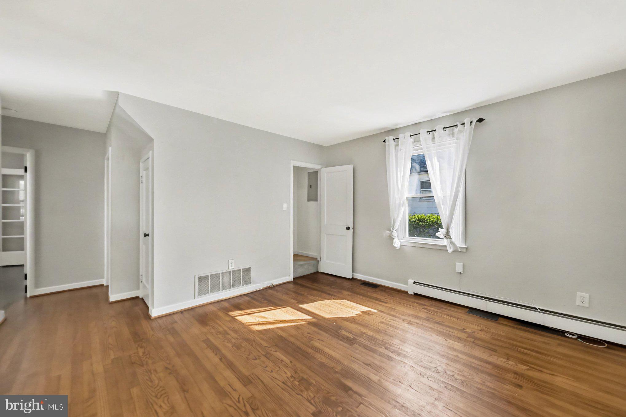 1750 Forrest Avenue Baltimore, MD 21234 - Photo 10 of 25 an empty room with wooden floor and windows