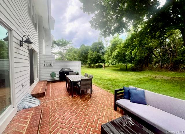 25 Mitchell Road, Unit 3 Westhampton Beach, NY 11978 - Photo 18 of 18 a patio view with a garden and outdoor seating