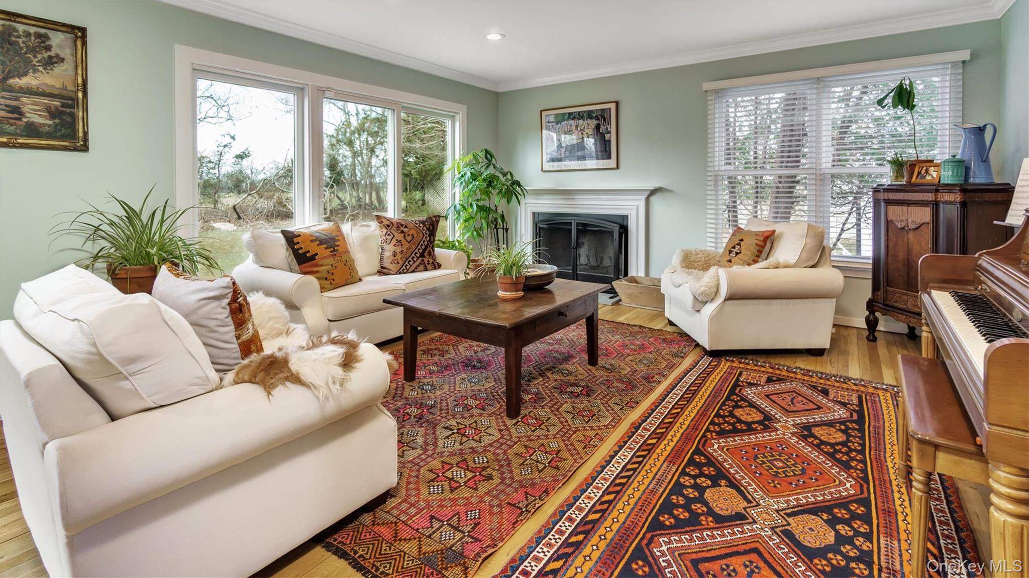 25 Mitchell Road, Unit 3 Westhampton Beach, NY 11978 - Photo 3 of 18 a living room with furniture fireplace and large windows
