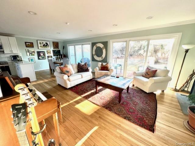 25 Mitchell Road, Unit 3 Westhampton Beach, NY 11978 - Photo 5 of 18 a living room with furniture and a large window