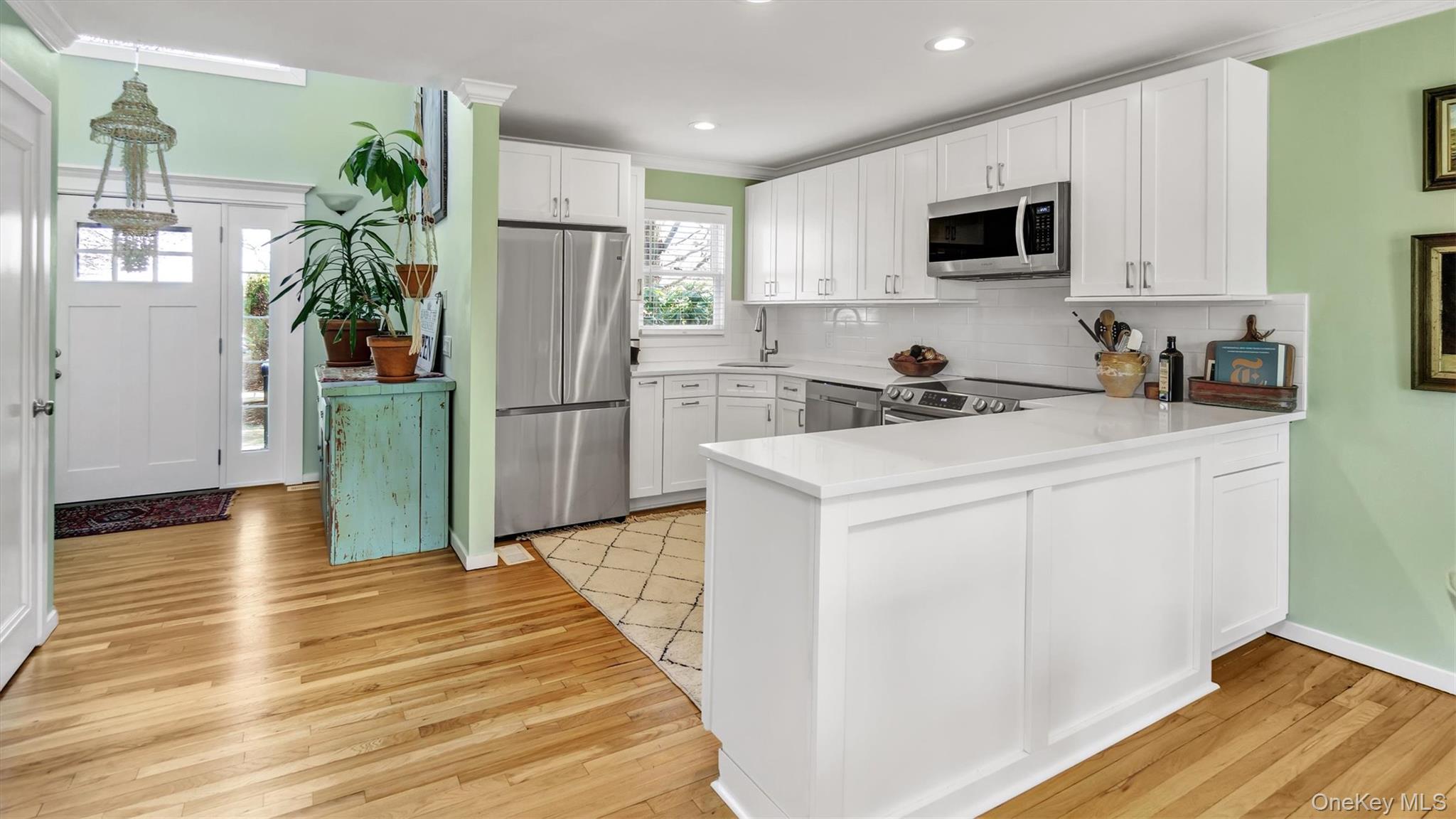 25 Mitchell Road, Unit 3 Westhampton Beach, NY 11978 - Photo 6 of 18 a kitchen with a refrigerator sink and microwave
