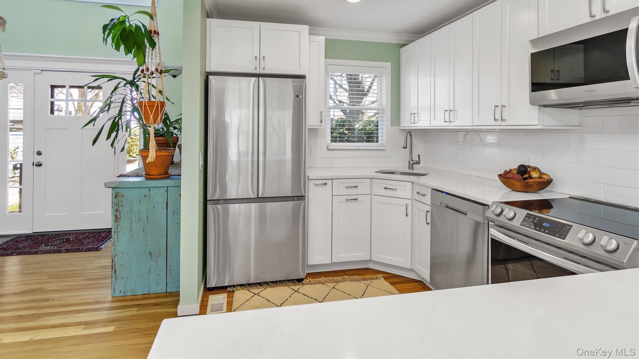 25 Mitchell Road, Unit 3 Westhampton Beach, NY 11978 - Photo 7 of 18 a kitchen with a refrigerator and a stove