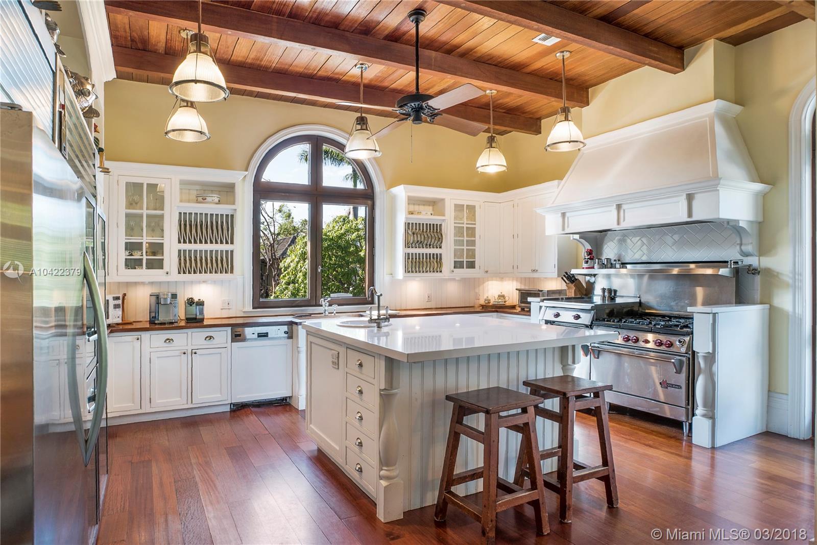 14 Harbor Point Key Biscayne, FL 33149 - Photo 14 of 45 a kitchen with stainless steel appliances granite countertop a stove a refrigerator a kitchen island with a stove and white cabinets