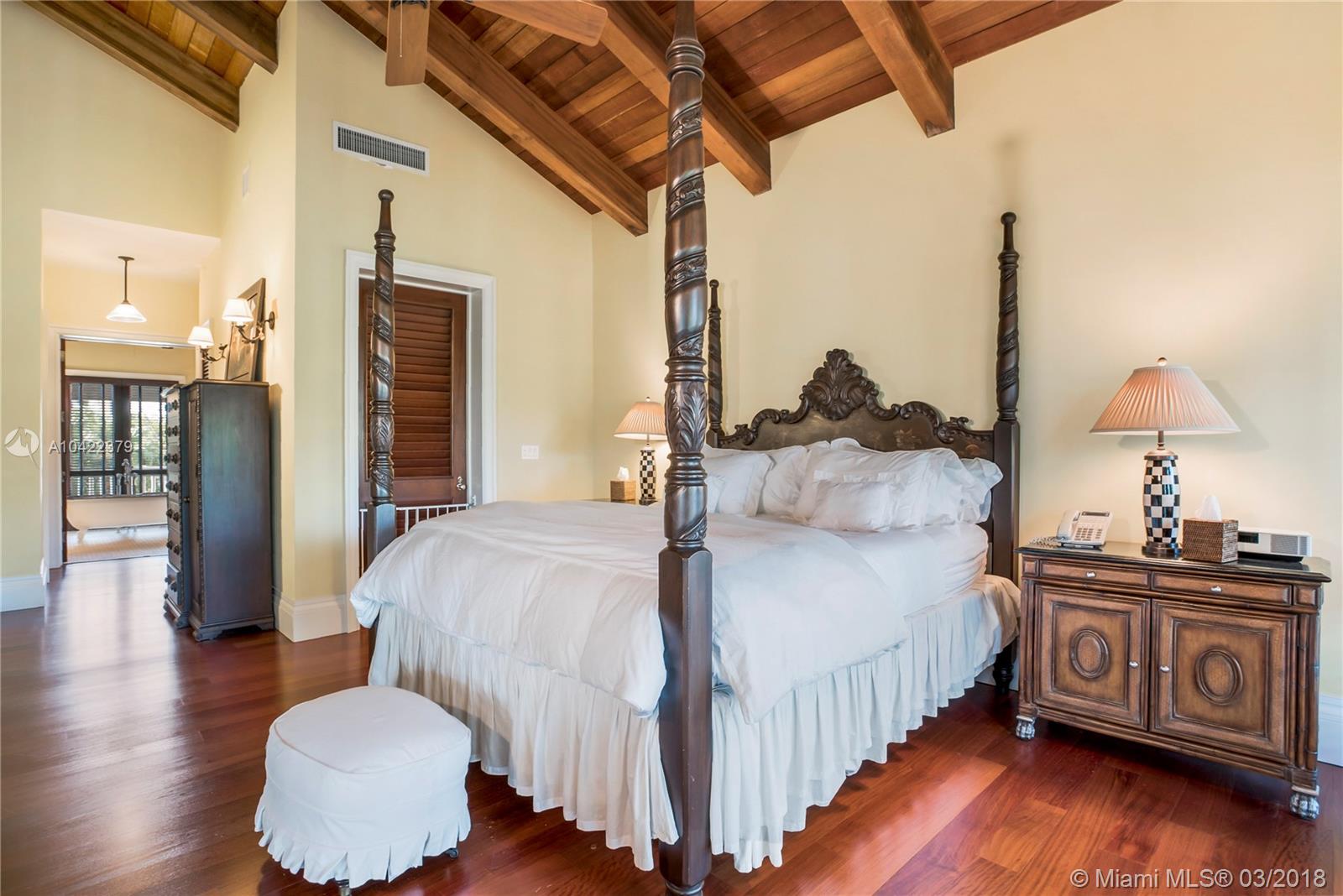 14 Harbor Point Key Biscayne, FL 33149 - Photo 20 of 45 a bedroom with a bed and wooden floor