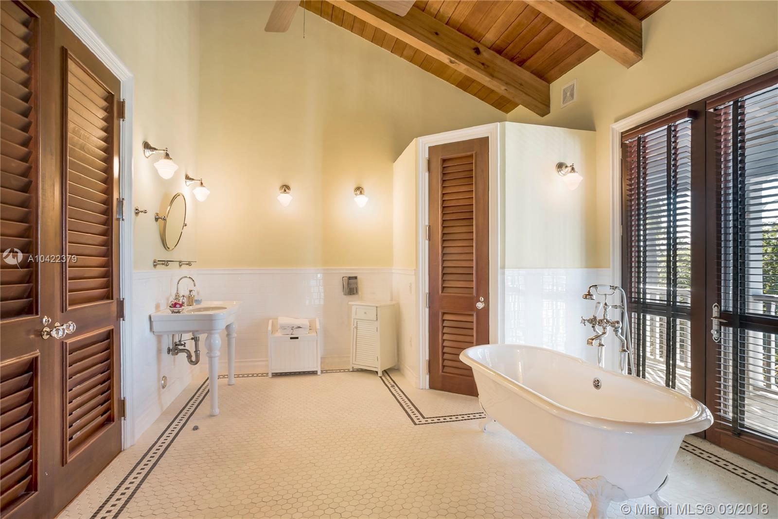 14 Harbor Point Key Biscayne, FL 33149 - Photo 21 of 45 a bathroom with a white tub shower and mirror