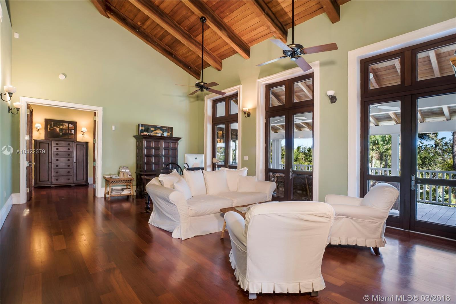 14 Harbor Point Key Biscayne, FL 33149 - Photo 10 of 45 a dining room with wooden floor a ceiling fan and windows