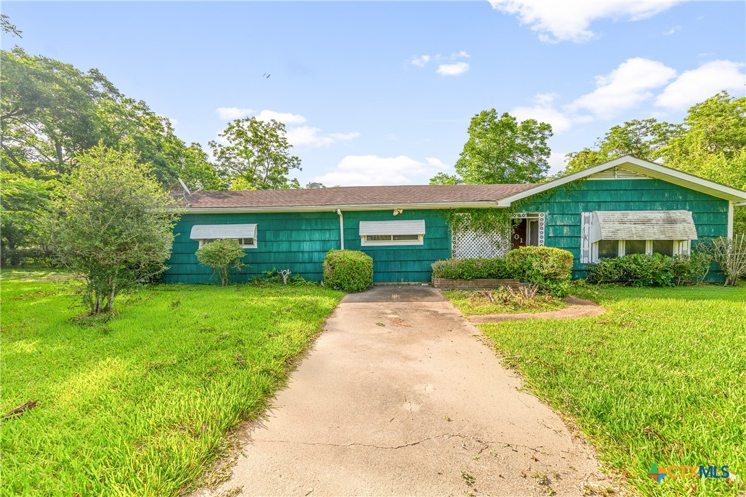 401 Kerr Street Edna, TX 77957 - Photo 6 of 23 a front view of a house with a garden