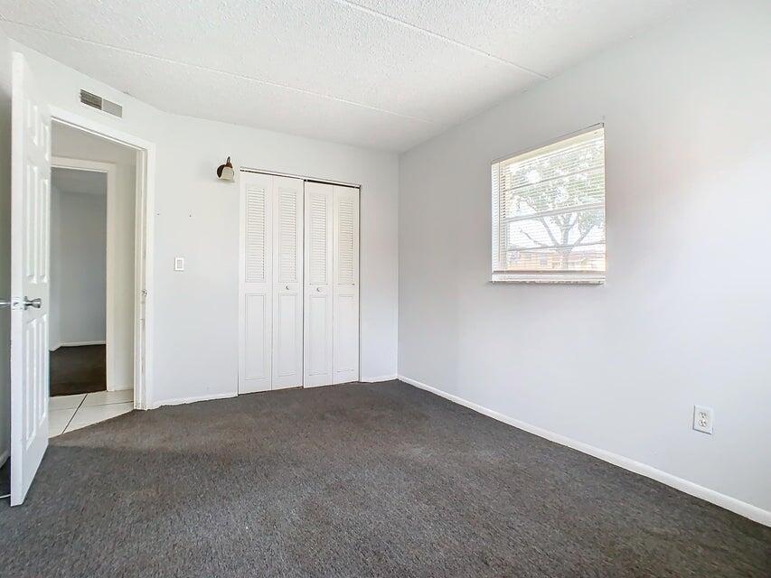 694 Michigan Court, Unit 3 St. Cloud, FL 34769 - Photo 14 of 24 an empty room with windows
