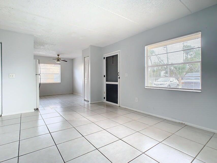 694 Michigan Court, Unit 3 St. Cloud, FL 34769 - Photo 3 of 24 a view of an empty room with a window