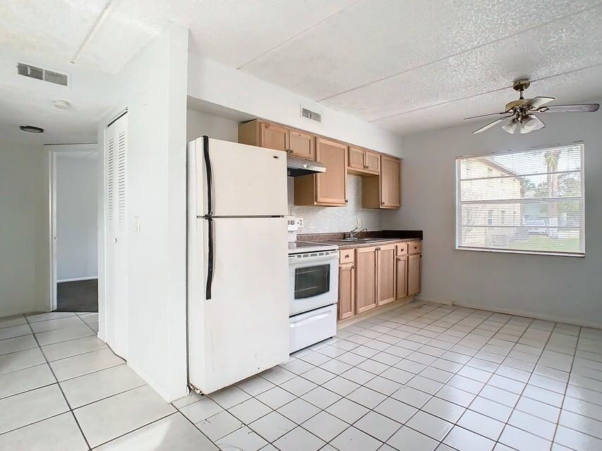 694 Michigan Court, Unit 3 St. Cloud, FL 34769 - Photo 8 of 24 a kitchen with stainless steel appliances a refrigerator sink and microwave