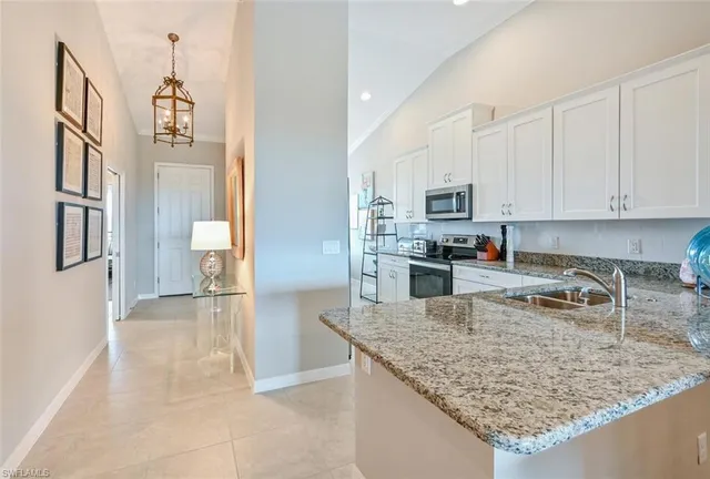 a kitchen with stainless steel appliances granite countertop a stove oven and a refrigerator