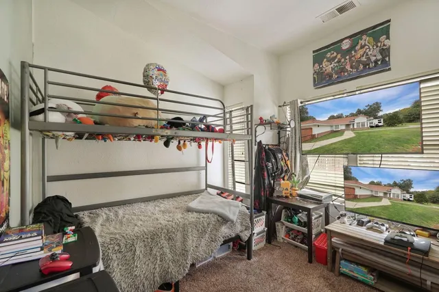 a bedroom with a bed and a window