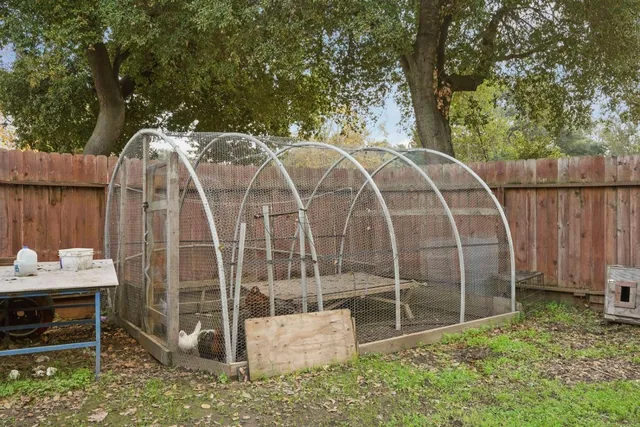 a backyard of a house with table and chairs