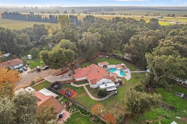 an aerial view of a house with a lake view