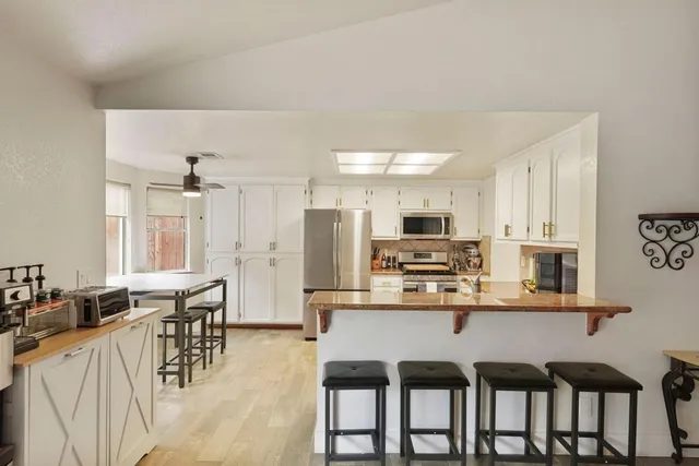 a large kitchen with a table and chairs