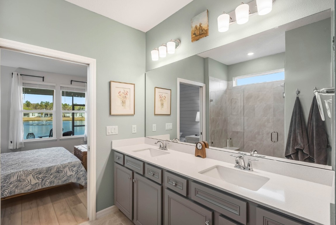 727 Cool Breeze Way Yulee, FL 32097 - Photo 12 of 34 a bathroom with a double vanity sink and a mirror