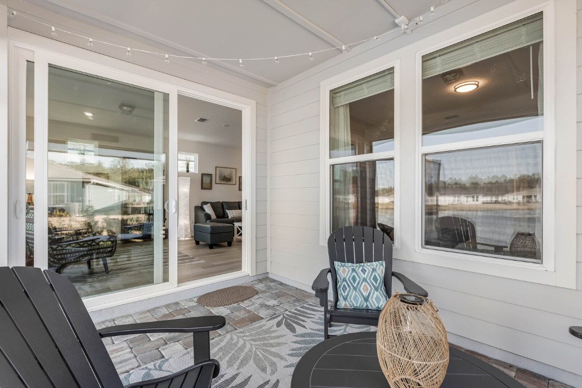 727 Cool Breeze Way Yulee, FL 32097 - Photo 17 of 34 a living room with furniture and a flat screen tv