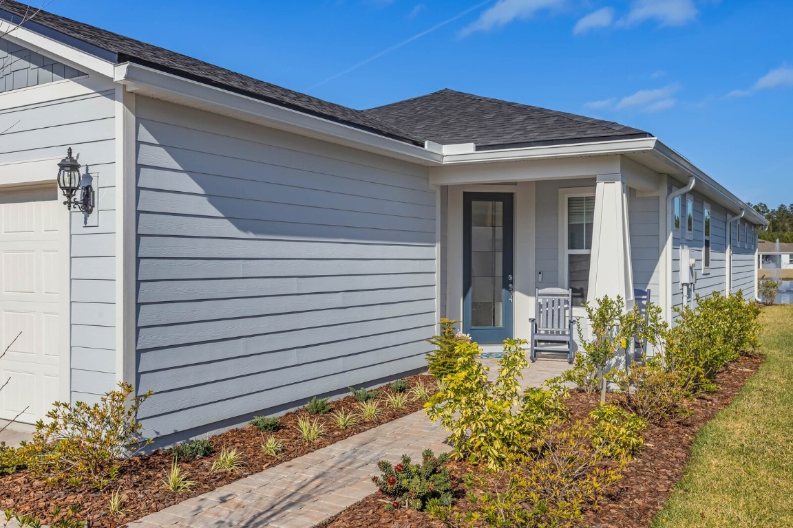 727 Cool Breeze Way Yulee, FL 32097 - Photo 21 of 34 a view of a house with window and flower plants