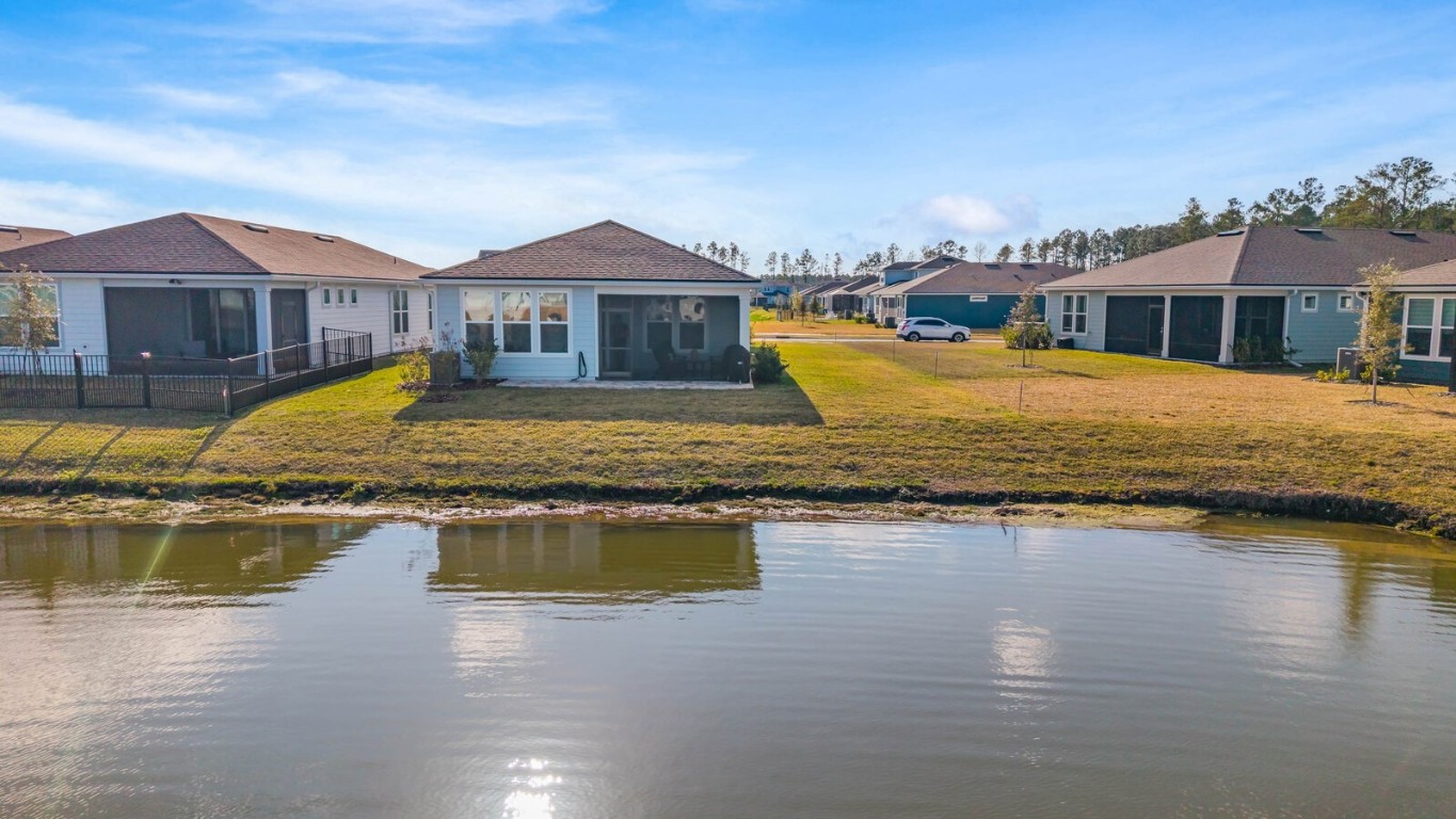 727 Cool Breeze Way Yulee, FL 32097 - Photo 26 of 34 a view of a house with swimming pool and a yard