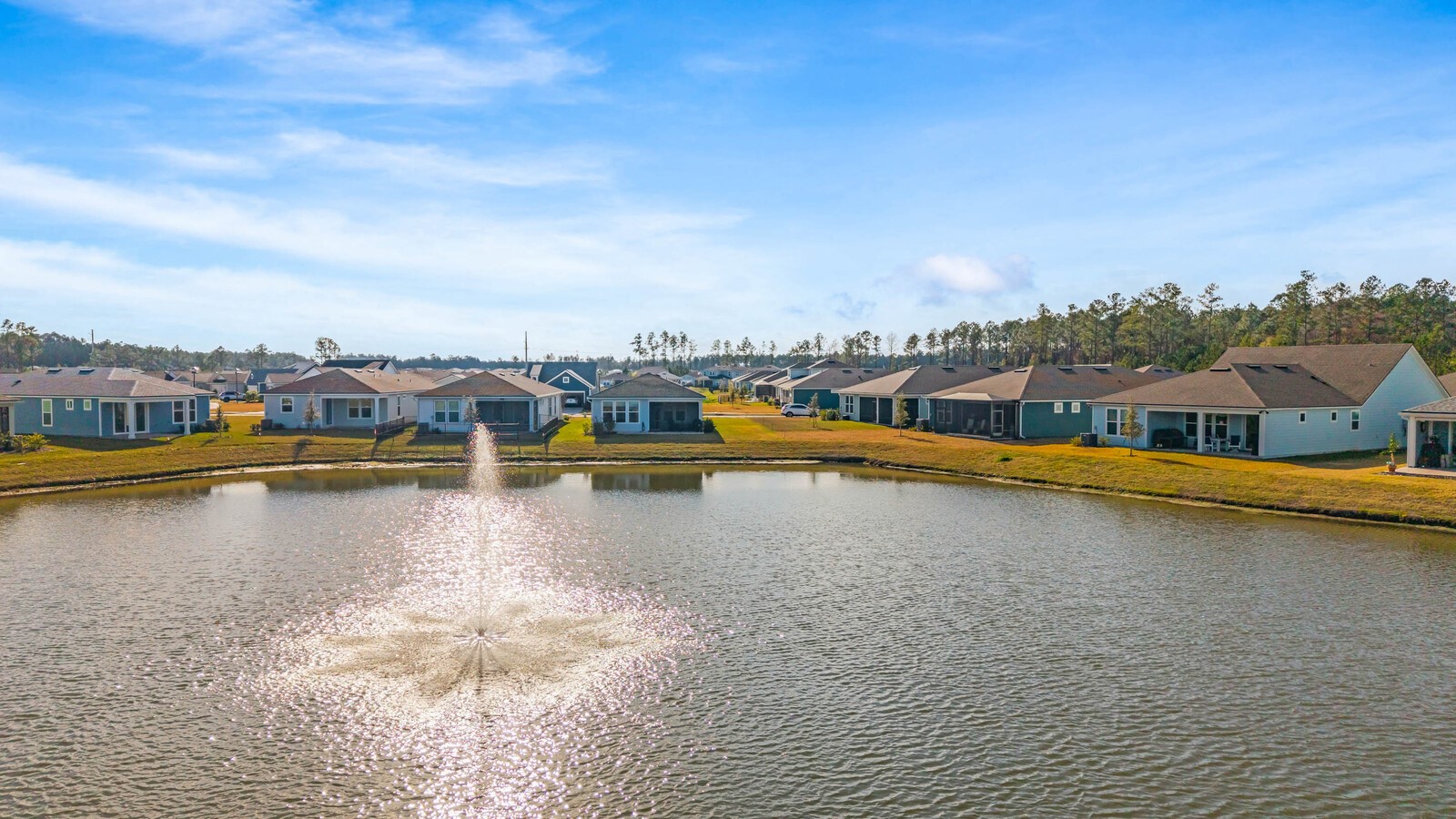 727 Cool Breeze Way Yulee, FL 32097 - Photo 26 of 31 a view of a lake with boats and trees in the background