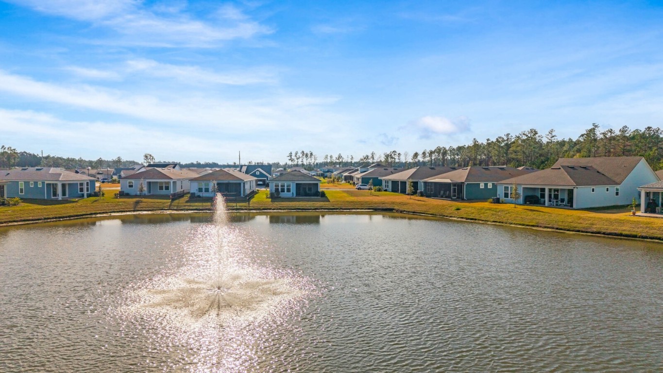 727 Cool Breeze Way Yulee, FL 32097 - Photo 28 of 34 a view of a lake with boats and trees in the background