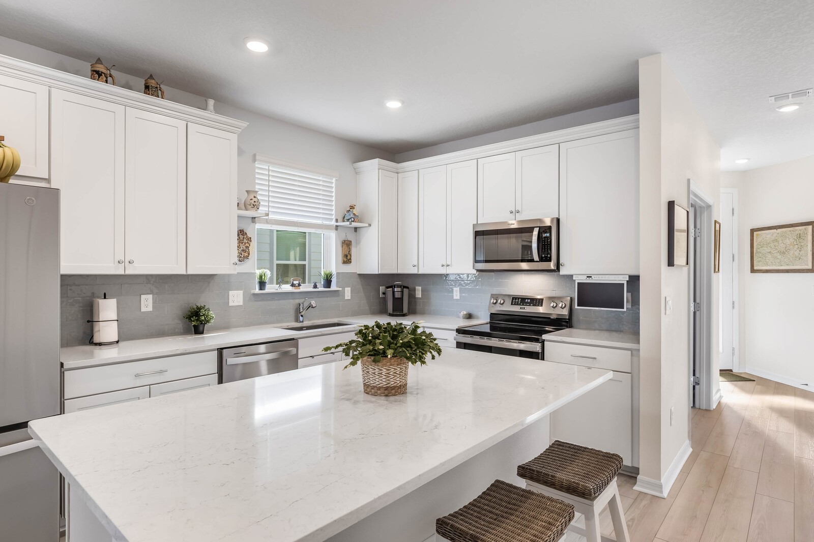 727 Cool Breeze Way Yulee, FL 32097 - Photo 5 of 31 a kitchen with stainless steel appliances a sink a stove a microwave a refrigerator a cabinets and wooden floor