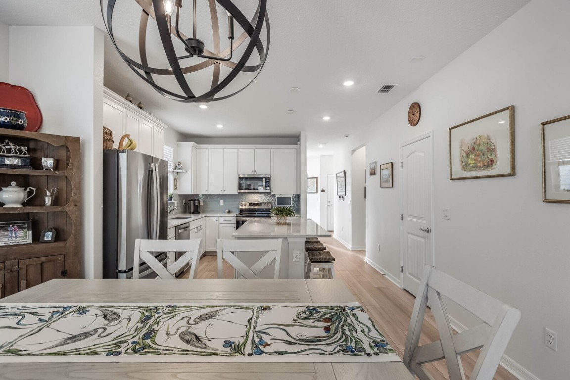 727 Cool Breeze Way Yulee, FL 32097 - Photo 6 of 34 a living room with stainless steel appliances kitchen island furniture and a view of kitchen