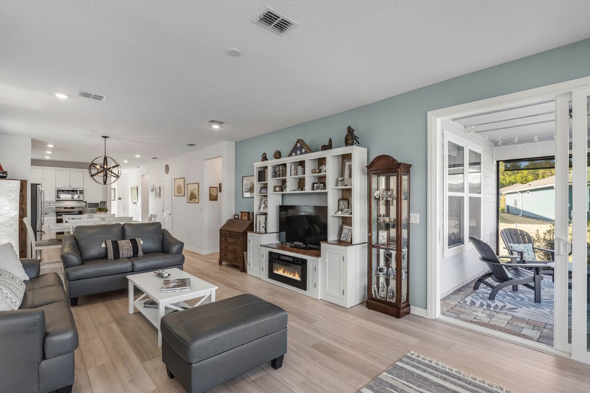 727 Cool Breeze Way Yulee, FL 32097 - Photo 8 of 34 a living room with furniture a flat screen tv and a refrigerator