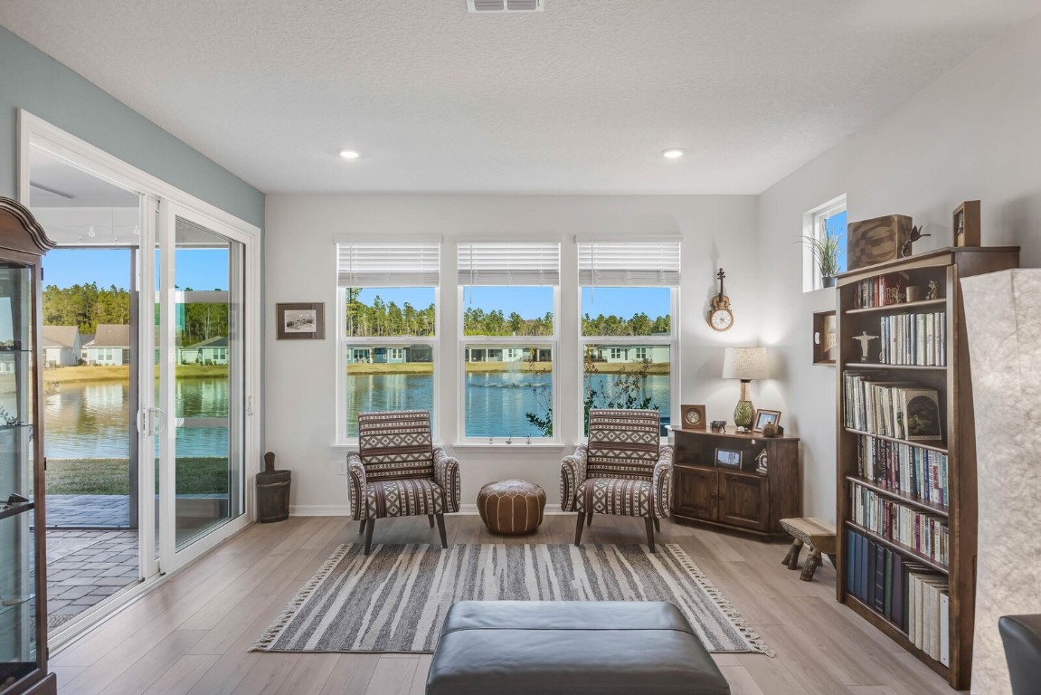 727 Cool Breeze Way Yulee, FL 32097 - Photo 9 of 34 a living room with furniture fireplace and wooden floor