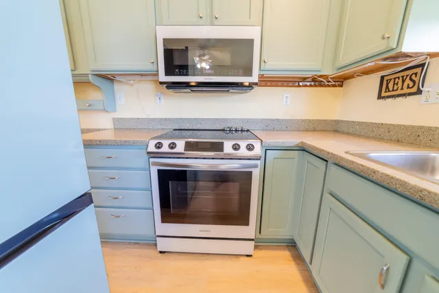 a bathroom with a sink vanity mirror and toilet