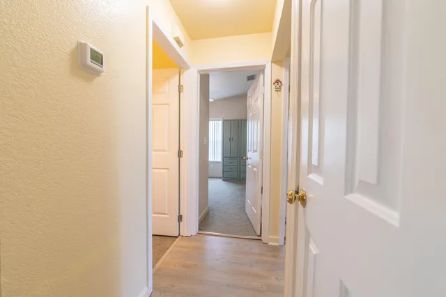 a view of a hallway with wooden floor