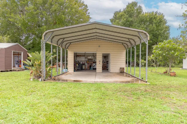 a view of a house with backyard and porch