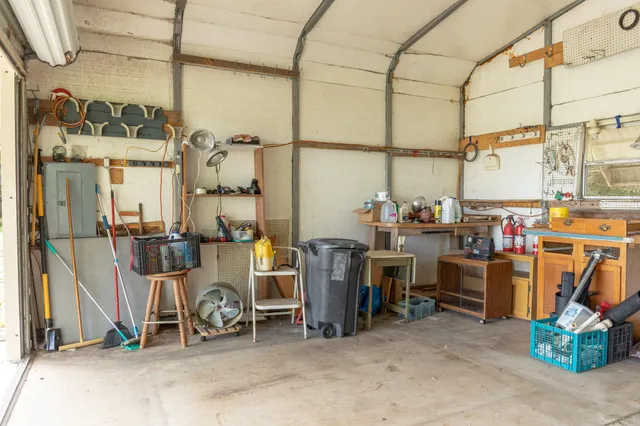 a view of a backyard with table and chairs and wooden fence