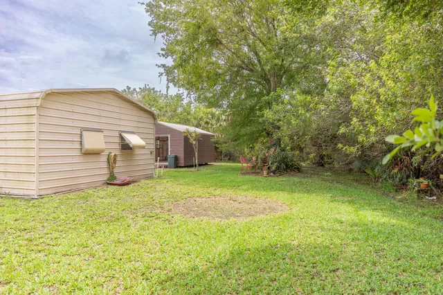 an aerial view of a house with a yard and lake view
